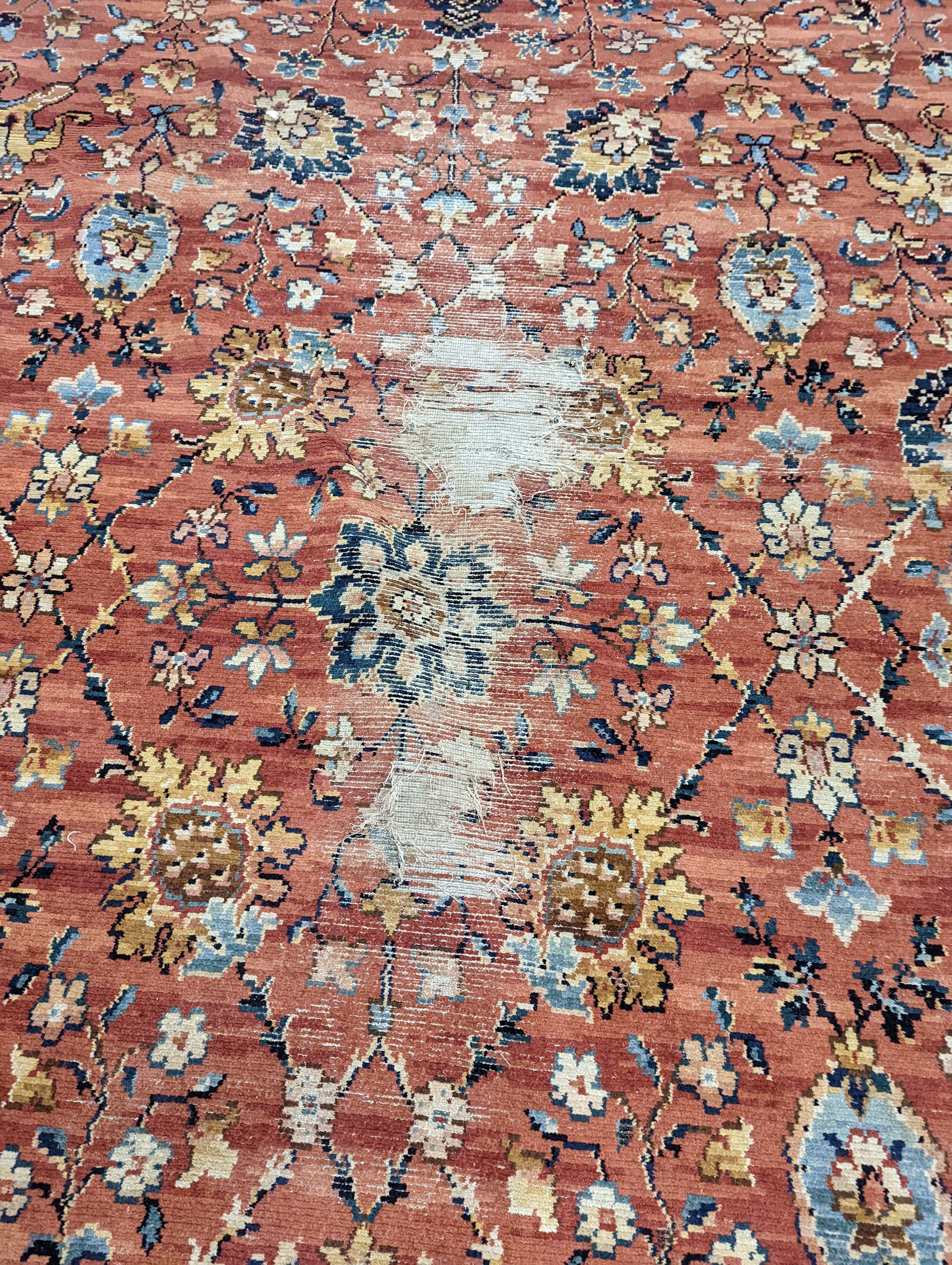 A Persian style machined brick red ground carpet (severely worn), 392 x 286cm